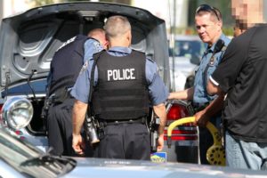 Police recover a parking boot from the trunk of a car