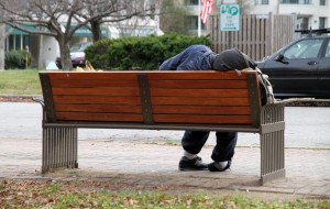 Homeless man on a bench outside Arlington Central Library