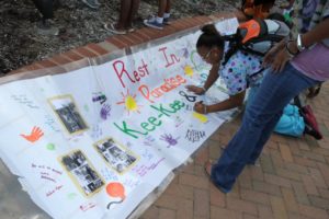 A candlelight vigil was held in the Hall's Hill community for homicide victims Keefe Spriggs and Carl Moten