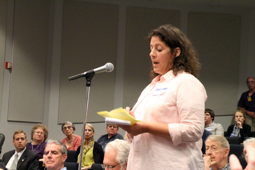 A woman asks a question at the candidates' forum