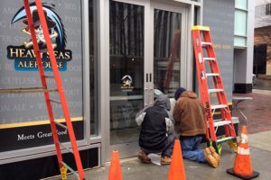 Workers affix signage to the door of the soon-to-open Heavy Seas Alehouse in Rosslyn Workers affix signage to the door of the soon-to-open Heavy Seas Alehouse in Rosslyn