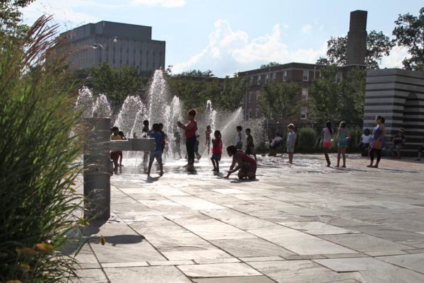 Kids play in the water jets at Penrose Square in Columbia Pike