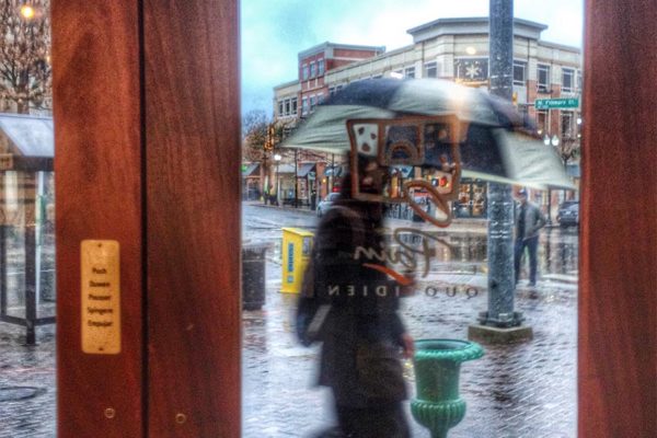 Woman with umbrella on a rainy day in Clarendon (Flickr pool photo by Dennis Dimick)