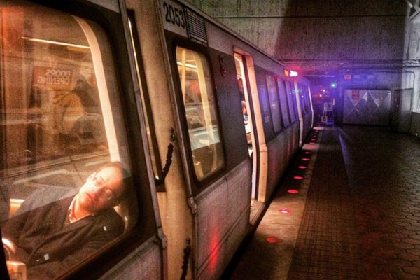 A commuter asleep on Metro in the Virginia Square station (Flickr pool photo by Dennis Dimick)