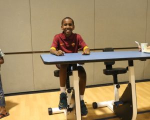 Student on a pedal desk