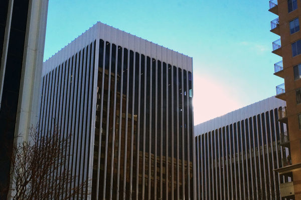 The sun drops behind an office building in Rosslyn