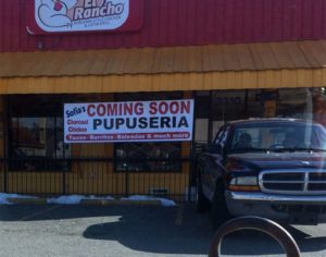 Sign announcing a new restaurant on the former El Rancho Peruvian Chicken eatery