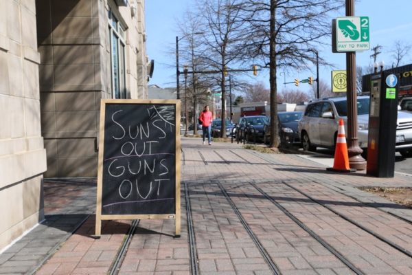 "Sun's Out, Guns Out" sign in Ballston