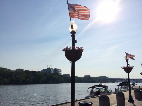 American flag at the Georgetown waterfront, with Rosslyn in the background