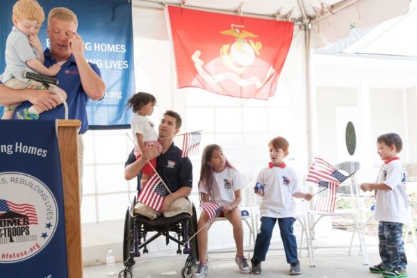 Chad Hackmann, owner Arlington Construction Management at Key ceremony with Sergeant Marcus Dandrea and family