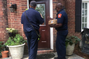 Firefighters checking smoke alarms