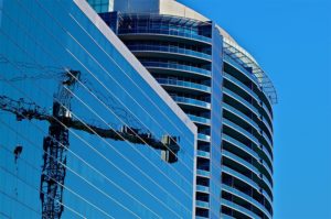 The reflection of a crane seen on a building in Arlington (photo by Wolfkann)